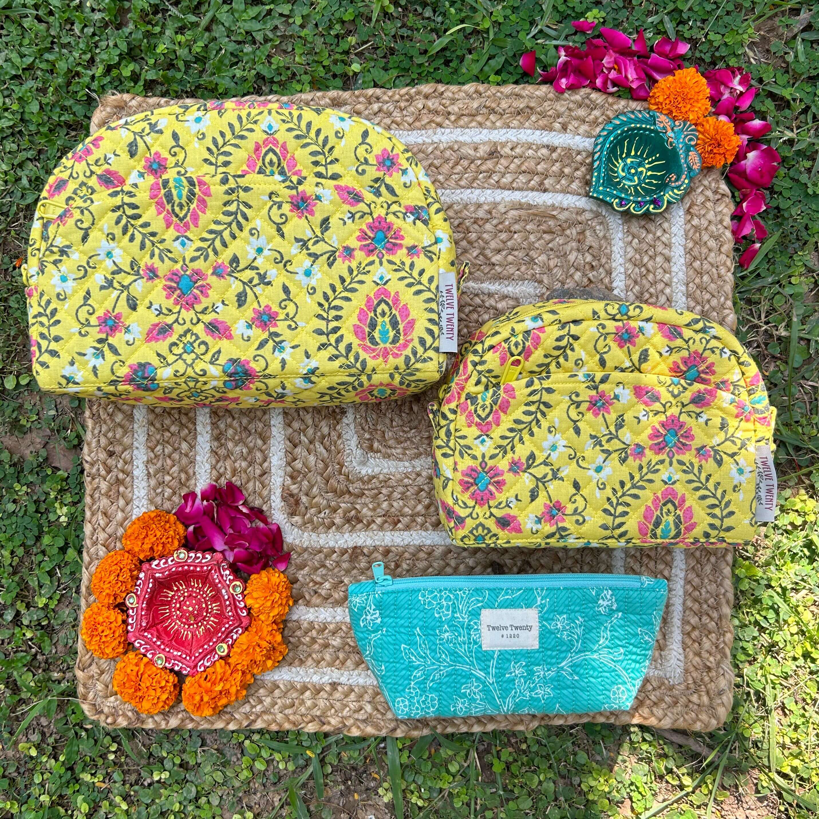 Vibrant Trinity Set of 3 with floral design showing 2 makeup bags and 1 everyday pouch on a natural woven mat.