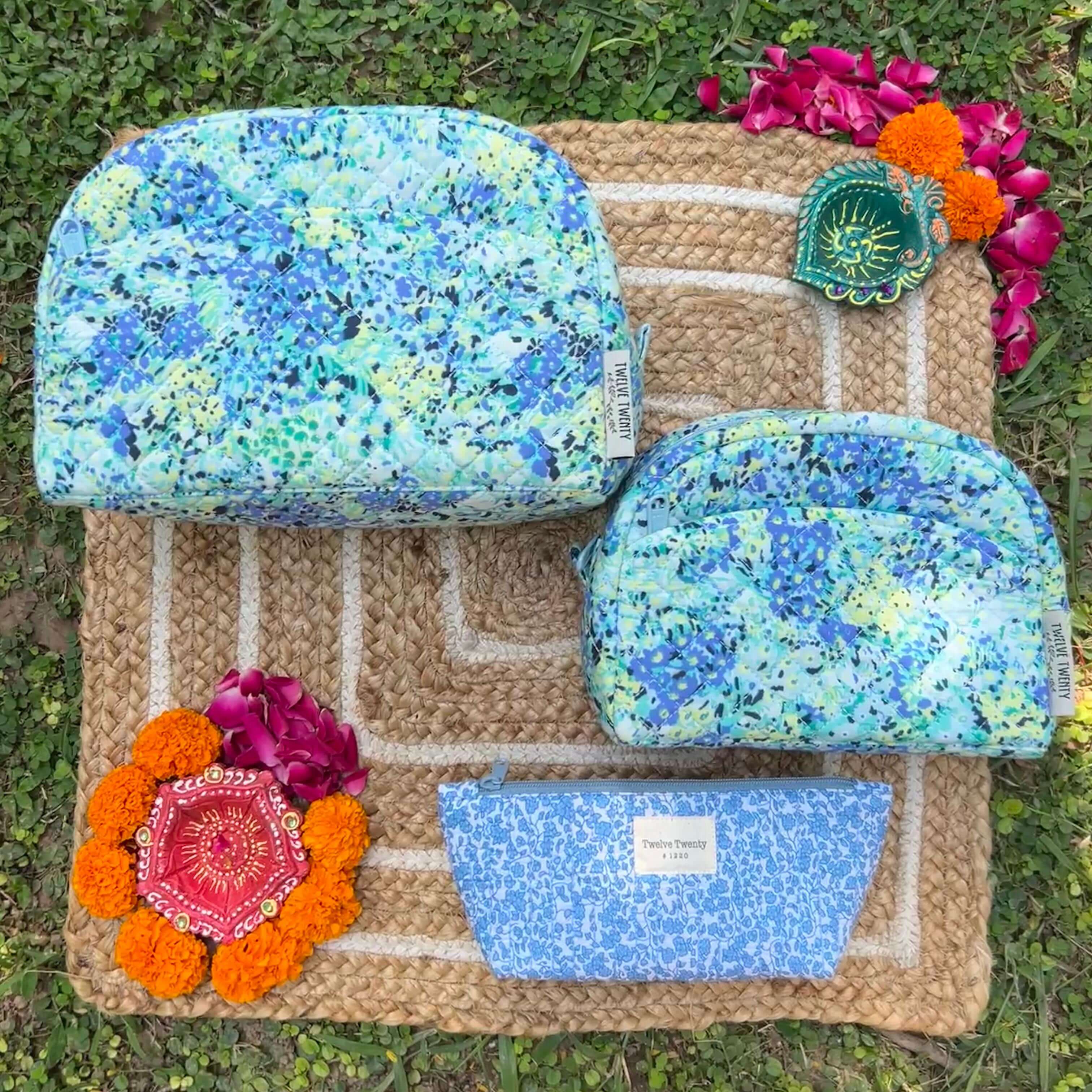 Trinity set of 3 makeup bags and everyday pouch with vibrant floral design, ideal for cosmetics and easy cleaning.